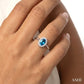 5X3 MM Oval Shape Blue Topaz and 1/20 Ctw Round Cut Diamond Halo Semi-Precious Ring in 10K White Gold