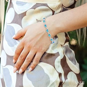 6X4 MM Oval Cut Blue Topaz and 1/10 Ctw Round Cut Diamond Semi-Precious Bracelet in Sterling Silver