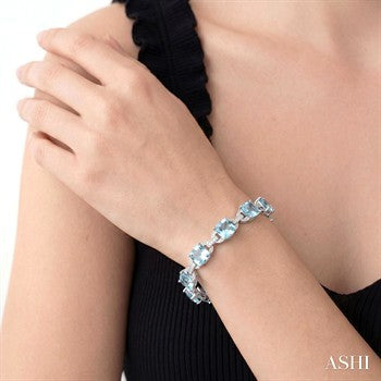 7X7 MM Cushion Shape Blue Topaz and 1/20 Ctw Round Cut Diamond Fashion Bracelet in Sterling Silver