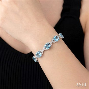 7X7 MM Cushion Shape Blue Topaz and 1/20 Ctw Round Cut Diamond Fashion Bracelet in Sterling Silver