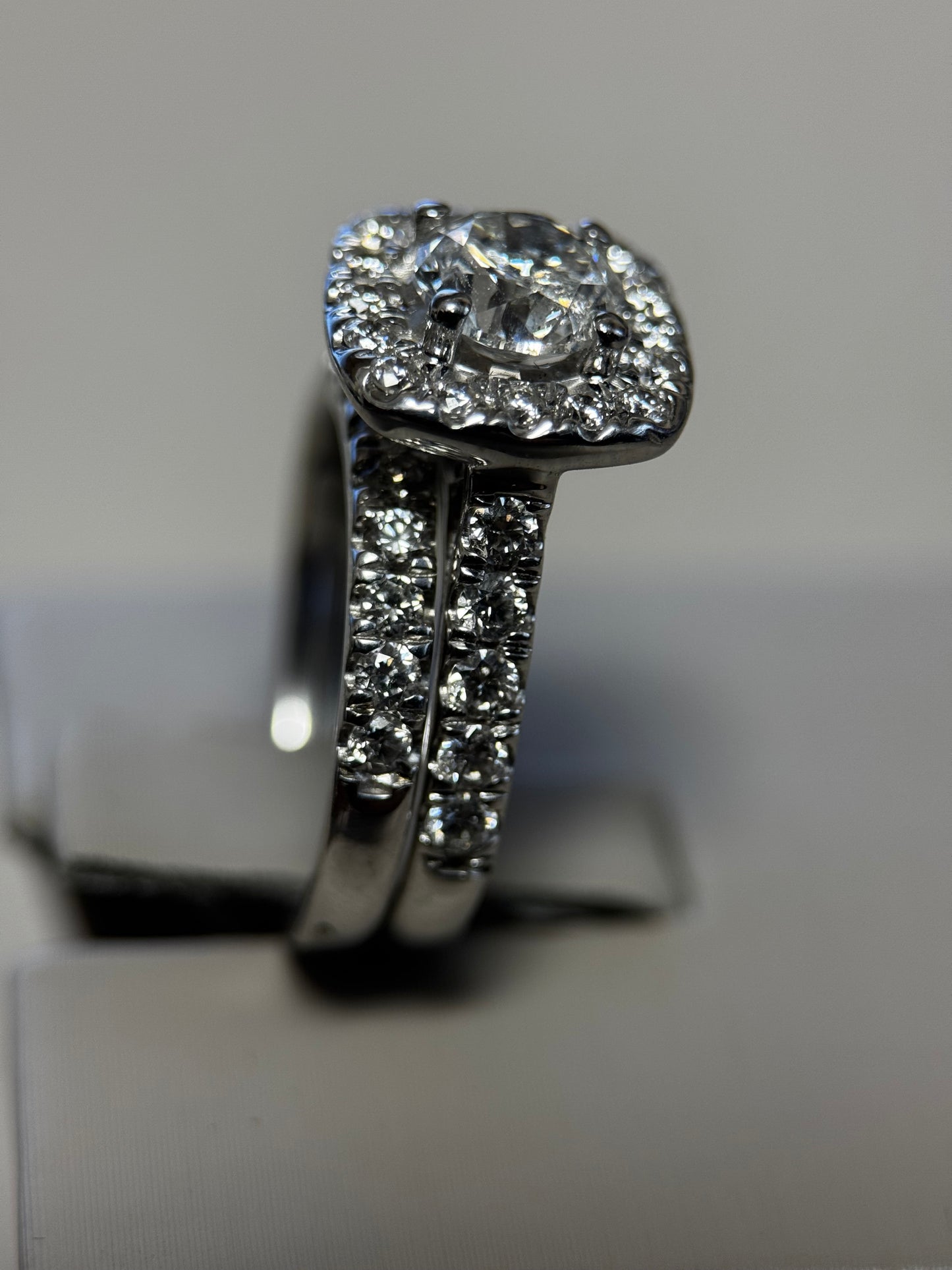 14K white gold halo wedding set with 1ct round diamond. Brilliant halo & matching band for timeless sparkle and elegance