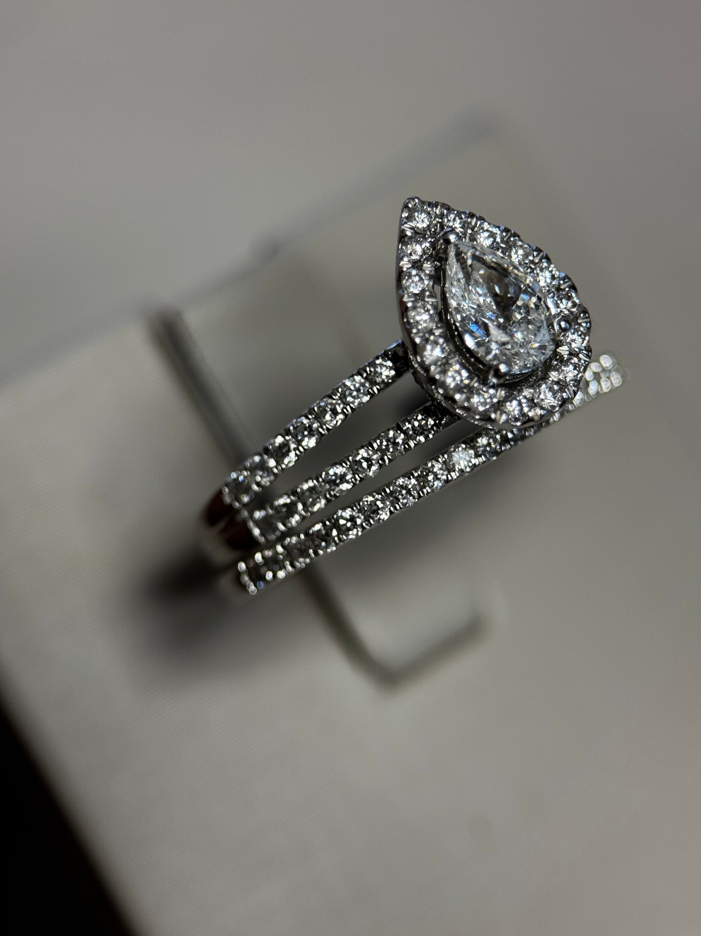 Romantic 14K white gold pear halo wedding set with .25ct center and 1ct total diamonds. Elegant sparkle and timeless beauty