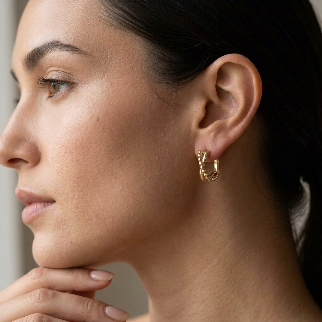 Gabriel & Co. 14K Yellow Gold Bujukan Twisted Huggie Earrings - worn lifestyle photo