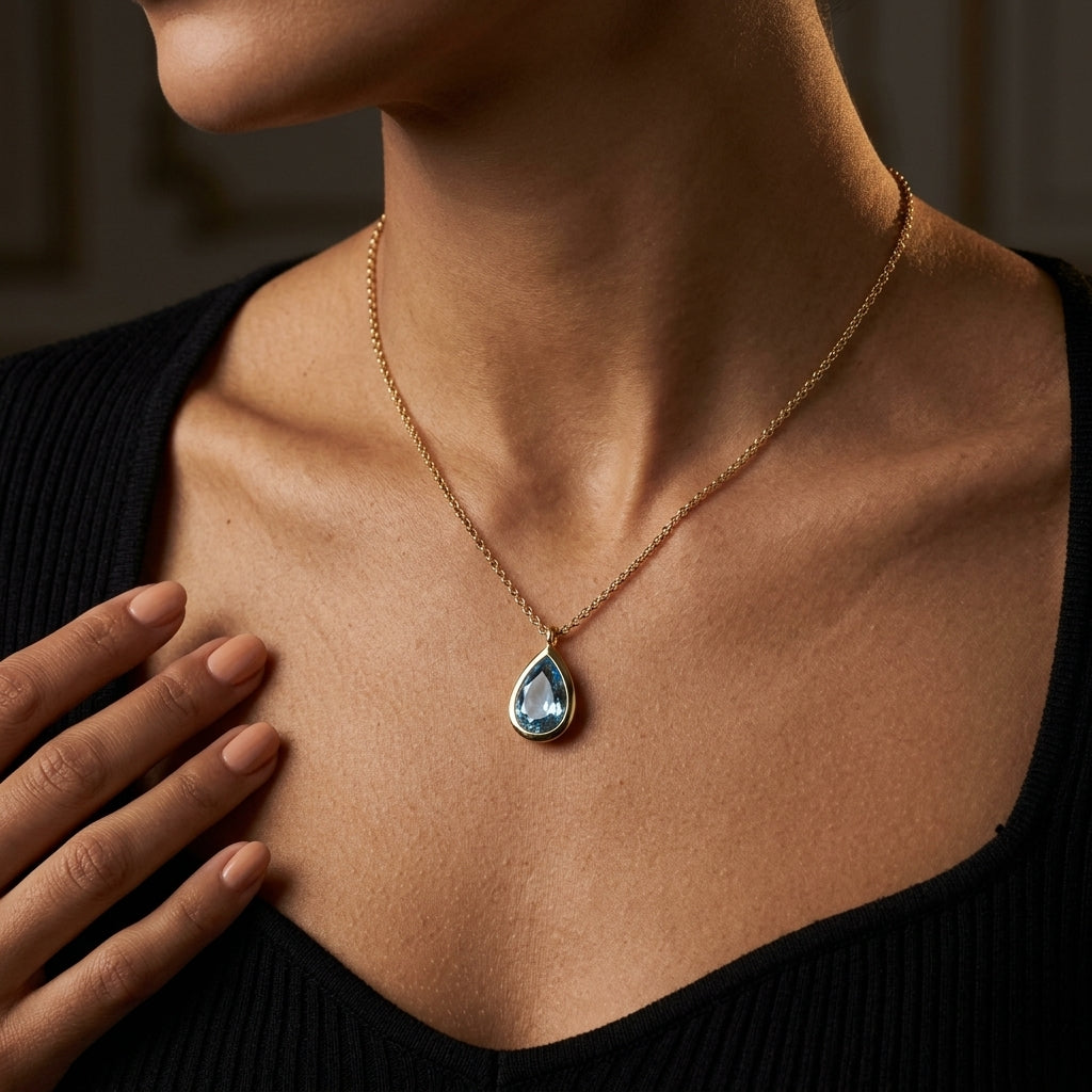 Gabriel & Co. 14K Yellow Gold Teardrop Blue Topaz Pendant Necklace - worn lifestyle photo