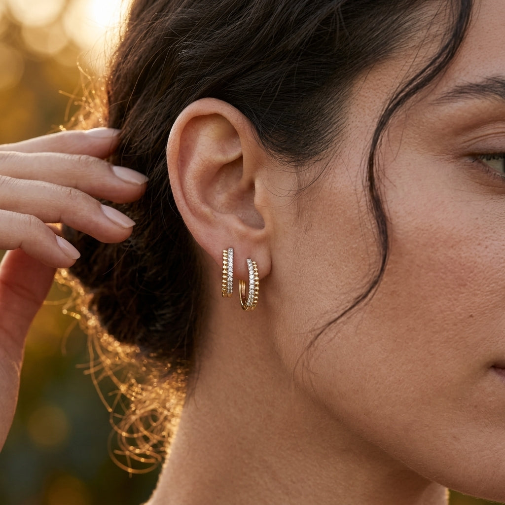 Gabriel & Co. 14K YELLOW GOLD BUJUKAN PAVE 10MM DIAMOND HUGGIE EARRINGS - worn lifestyle photo