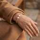 Gabriel & Co. 14K Yellow Gold Bujukan Diamond and Pearl Split Bangle .05CTW SZ 6 - worn lifestyle photo