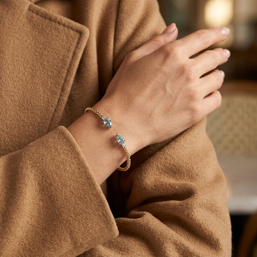 Gabriel & Co. 14K White Yellow Gold Bujukan Open Cuff Bracelet with Blue Topaz and Diamond End Caps SZ 6 - worn lifestyle photo