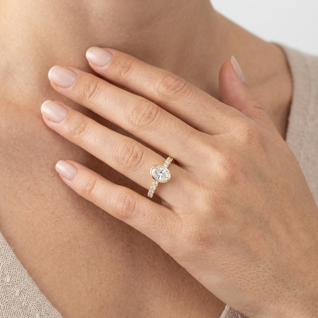 1/2 Ctw Luna Bezel East-West Oval Cut and Round Cut Diamond Ring in 14K Yellow Gold - worn lifestyle photo